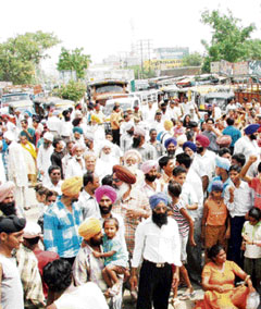 Residents of ward no. 31 block Gill Road to protest the scarcity of water in Ludhiana on Tuesday.