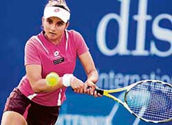 Sania Mirza hits a return to Italys Maria Elena Camerin during her first-round match at the DFS Classic tennis tournament in Birmingham