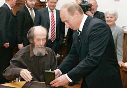 Russias President Vladimir Putin (right) hands Alexander Solzhenitsyn the State Prize for his achievements in the humanitarian field as the president visits his home in Troitse-Lykovo in Moscow