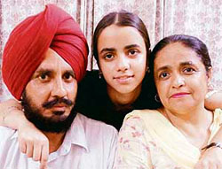 Harsimran Kaur (with her parents), who stood 11th in the state and topped Kharar district.