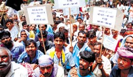 Rickshaw-pullers protest against the CNG bus service in Chandni Chowk after the ban on rickshaws there in the Capital on Wednesday. 