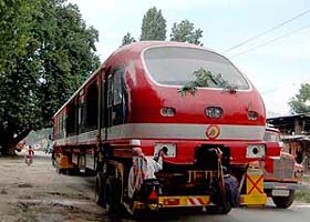 A train engine mounted on a truck reaches Srinagar
