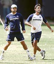 Sachin Tendulkar (left) and Dinesh Karthik warm up on the first day of the camp at the Chinnaswamy Stadium in 