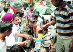 Sweetened water is offered to passersby at a "chabeel" in front of the Divisional Commissioner office in Jalandhar on Thursday in view of the rising temperature in the region.