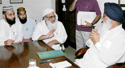 The Shahi Imam of Jama Masjid,Maulana Habib-ur-Rehman Sanvi,explains a point to Chief Minister Parkash Singh Badal at a meeting in Chandigarh