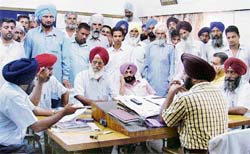 Members of the Kirti Kisan Union in the office of the PSEB superintending engineer in Ludhiana