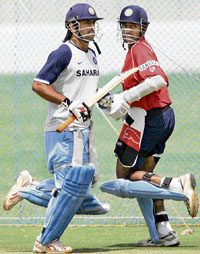 Mahendra Singh Dhoni (left) and Robin Uthappa run between the wickets during a practice session at the Chinnaswamy Stadium in Bangalore on Thursday.