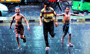 Boys revel in the rain in the Capital on Friday.