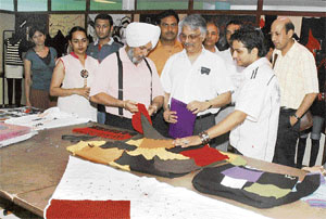 Knitwear industrial experts examines the creations of SIFT students during an exhibition held in Ludhiana on Friday.