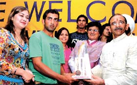 Delhi Pradesh Congress president Ram Babu Sharma presents a momento to Indian cricketer Goutam Gambeer during a felicitation function organised by the DDCA at Ferozshah Kotla Stadium in the Capital