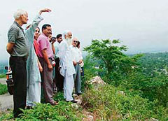 Noted environmentalist Sunder Lal Bahuguna (second from right) visits the site for a cement plant near Sundernagar on Sunday.