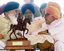 Punjab Chief Minister Parkash Singh Badal makes a point with former Governor of Goa Bhanu Prakash Singh in Pathankot on Sunday.