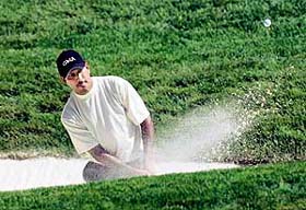 Jeev Milkha Singh hits out of a bunker during the third round of the US Open Golf Championship at the Oakmont Country Club in Pennsylvania