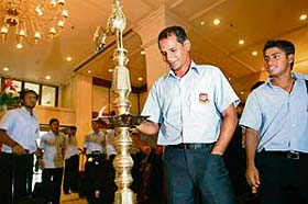 Bangladeshs former captain Habibul Bashar lights a traditional lamp as newly appointed captain Mohammad Ashraful looks on upon the teams arrival at a hotel in Colombo