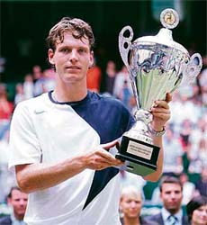 Czech Republics Tomas Berdych holds the trophy after beating Cypriot Marcos Baghdatis in the final of the ATP tennis tournament at the Gerry-Weber-Stadium in Halle, Germany