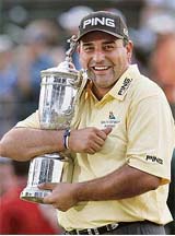 Argentinas Angel Cabrera clutches his prized possession after winning the US Open Golf Championship at the Oakmont Country Club in Pennsylvania on Sunday. 