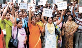 CGHS employees demonstrate for their demands in front of the CGHS headquarters in the Capital