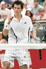 Britains Tim Henman celebrates after beating Michael Russell of the US during the Nottingham Open tennis tournament on Tuesday. Henman won 6-1, 7-6.