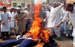 Protesters burn Salman Rushdies effigy in Jammu on Friday.  Tribune photo by Anand Sharma