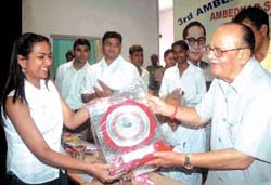 Union HRD Minister Arjun Singh presenting 3rd Ambedkar Ratna Samman to Radhika Bansal who has secured 97.4% marks in 12th class, at a function organised by Ambedkar Students Organisation in the Capita