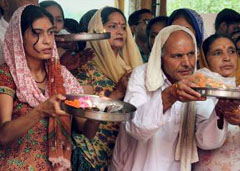 Devotees offer prayers during the annual fair at the Kheer Bhawani temple in Jammu on Saturday.