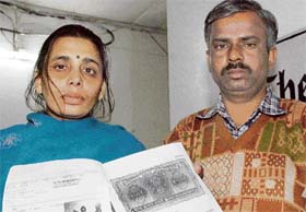Sumitra Devi and her husband Ram Raj show documents of the land where they want to construct a house in Ludhiana