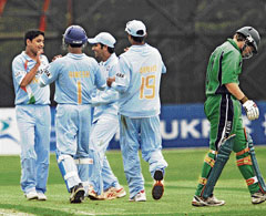 Piyush Chawla (left) celebrates with team-mates after taking the wicket of Irelands Gary Wilson during the one-dayer at the Stormont cricket ground in Belfast on Saturday.