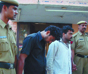 The accused constable and his accomplice in police custody.