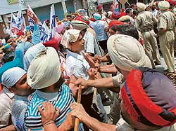 Police personnel try to stop members of the Education Volunteer Teachers Union, Punjab, from going to education minister Dr Upinderjeet Kaurs house on the Sultanpur Lodhi road in Kapurthala on Sunday.
