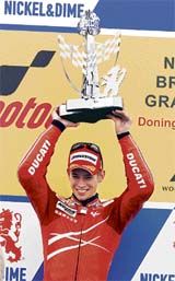 Australias Casey Stoner holds his trophy as he celebrates winning the 500cc British Moto Grand Prix at Donington Park on Sunday. Stoner extended his overall world championship lead after claiming his fifth victory of the season.