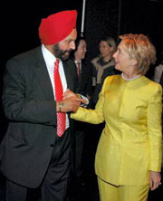 Democratic presidential hopeful Hillary Clinton, is received by Sant Chatwal, chairman of the event at an Indian-American fund raiser dinner in New York on Sunday.