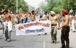 Unemployed B Ed teachers carry out shirtless protest from Sector 17 to Sector 25 rally ground in support of their demands in Chandigarh on Tuesday.