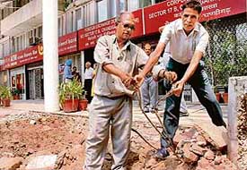 BSNL officials repair a damaged lease line of the zonal office of Punjab National Bank in Sector 17, Chandigarh, on Wednesday.