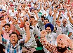 Members of the UT Powermen Union, Chandigarh, raise slogans against the authorities in Sector 17, Chandigarh, on Wednesday.