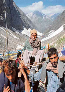 An aged devotee being carried on a palki to the 3880-metre-high holy shrine of Amarnath in South Kashmir on Wednesday.