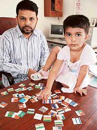 Anuroop Sharma with cardboard cutouts of national flags of different countries at her home in Bathinda