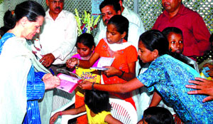 Congress President Sonia Gandhi gives autographs to thalassaemic children at her 10 Janpath residence in the Capital on Thursday.