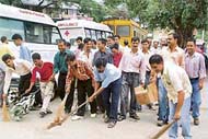 taxi operators clean the premises of Dr Rajendra Prasad Medical College and Hosiptal in Dharamsala on Thursday.