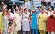 Brown Road residents stage a dharna in protest against waterlogging of their houses after showers on Thursday.