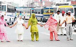 Members of the Education Volunteer Teachers Union, who blocked traffic near the Patiala bus stand