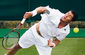 Russias Marat Safin serves to Pakistans Aisam Qureshi during a second-round match at Wimbledon
