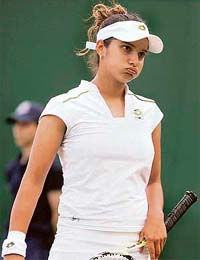 Sania Mirza reacts after losing to Russias Nadia Petrova in the second-round match at Wimbledon