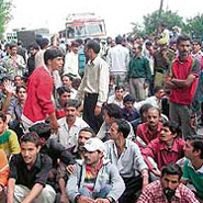Protesting taxi drivers block traffic in front of the RTO office in Shimla on Friday.