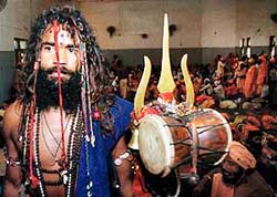 A sadhu stands in a queue to register himself for the Amarnath Yatra in Jammu