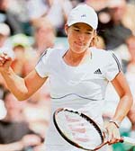 Belgiums Justine Henin celebrates after defeating Russias Elena Vesnina in the third round at Wimbledon in London