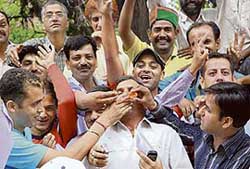 Taxi drivers rejoice in front of the DCs office after the government agreed to their demands in Shimla on Saturday.