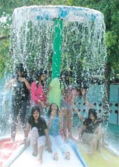 Children enjoying themselves at Appu Ghar Water Park to beat the heat in the Capital on Sunday.