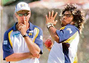 Sri Lankas coach Trevor Penney watches Lasith Malinga bowl during a practice session 