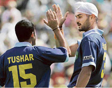 Indias Tushar Khandeker (left) congratulates team-mate Sandeep Singh after he scored a goal against England during the Champions Challenge hockey tournament in Boom, Belgium, on Sunday. India won 4-3.