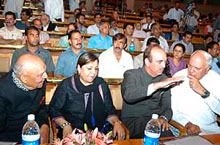 Former Chief Minister Farooq Abdullah talks with Chief Minister Ghulam Nabi Azad, while his wife Shameema Azad and Governor S. K. Sinha look on at the inaugural function of a Sufi festival at SKICC, Srinagar, on Monday